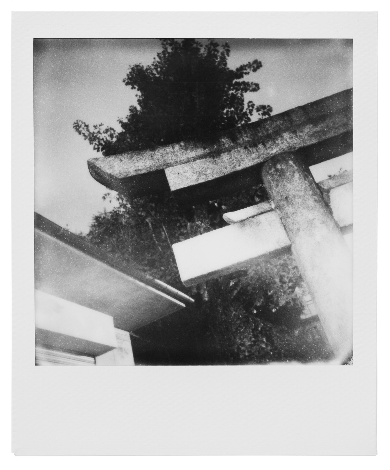 A traditional Japanese torii gate standing against a cloudy sky, embodying the transient essence of nature and mono no aware, symbolizing the ever-changing cycles of existence.