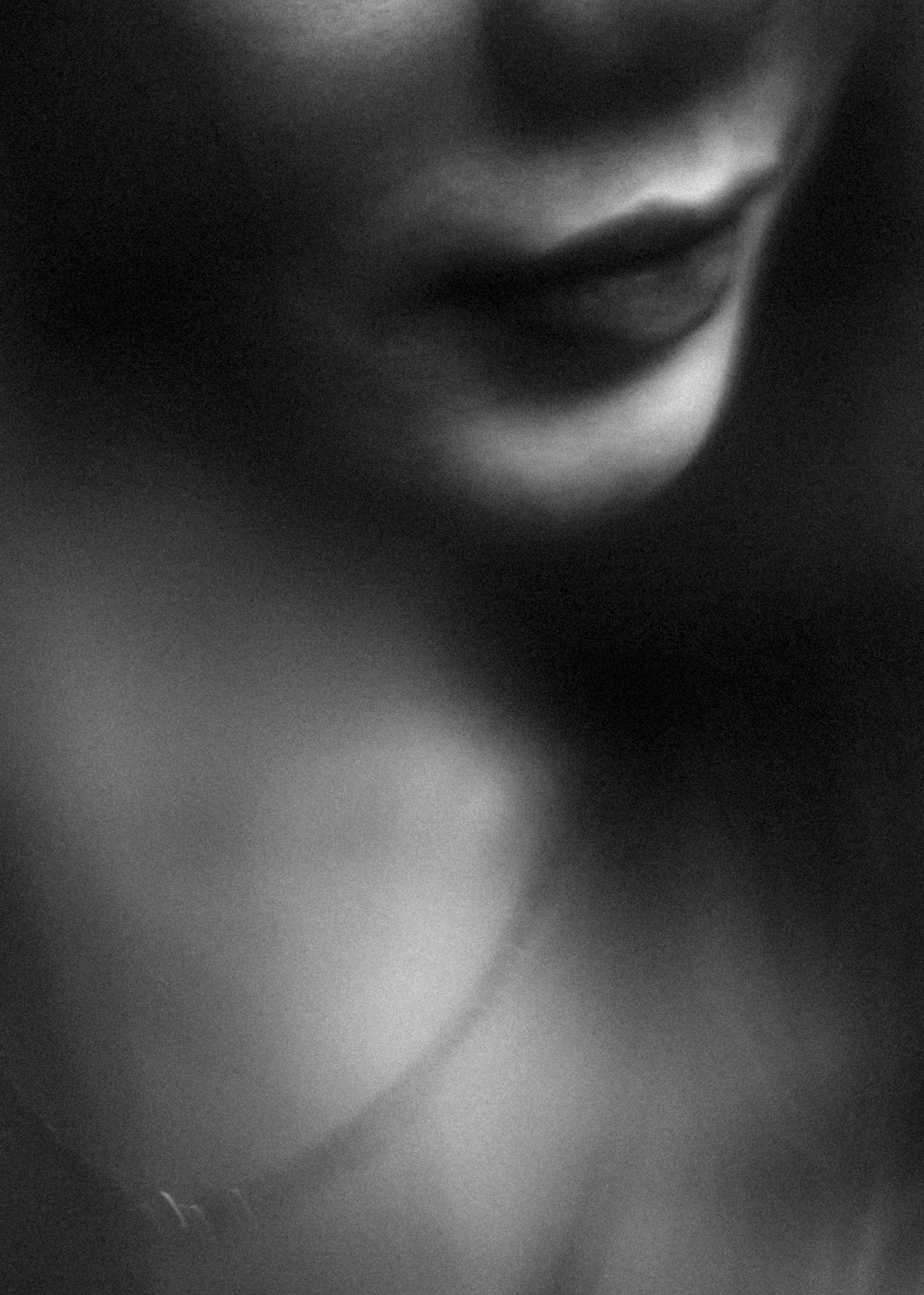 Abstract black and white close-up of a woman lips, evoking the essence of mono no aware through the fleeting nature of expression and the impermanence of beauty, captured in an ephemeral moment.