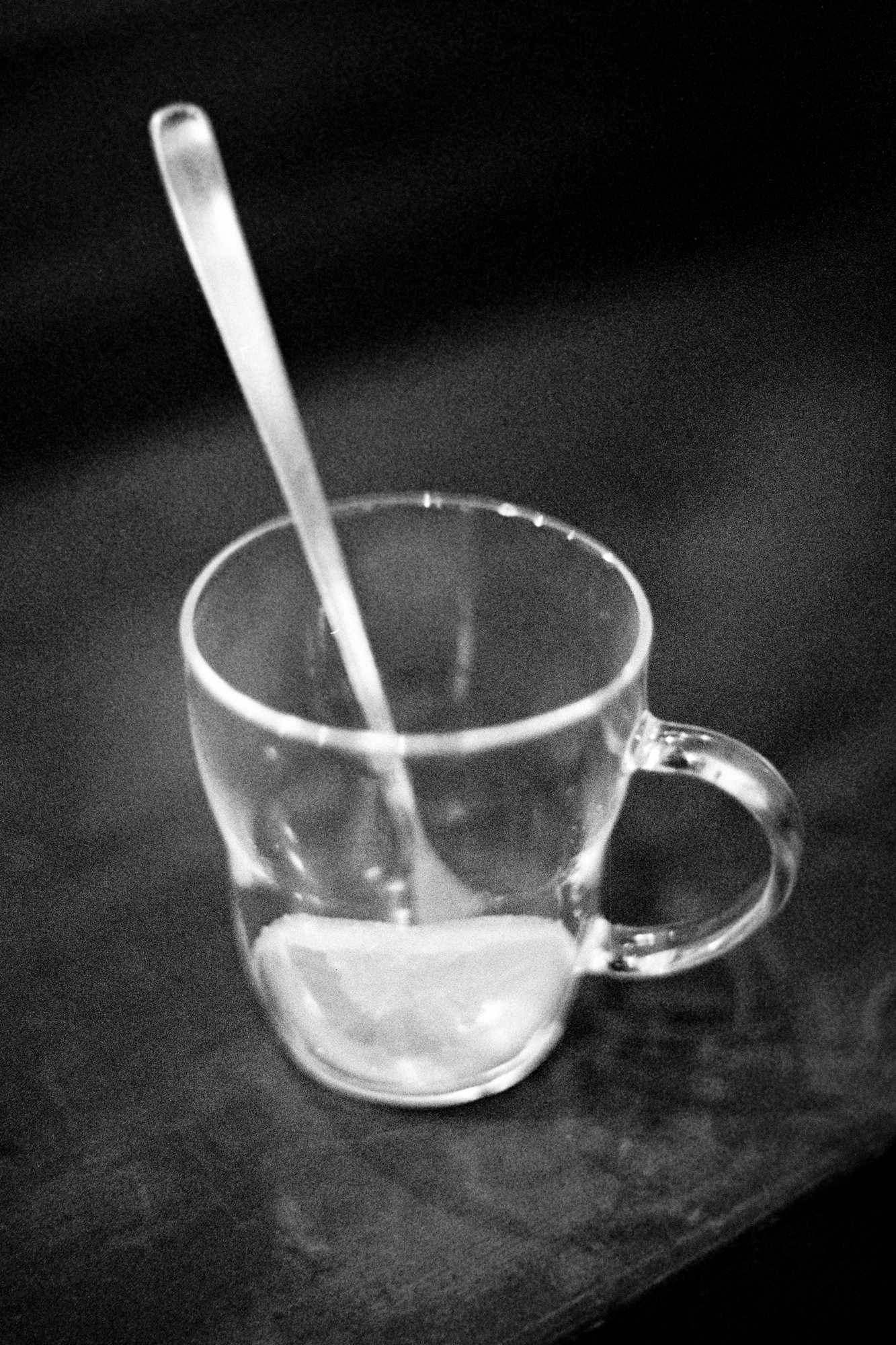 Black and white diptych of a full and empty glass cup of lemon tea, with a spoon resting inside.. This minimalist composition symbolizes impermanence and the fleeting nature of time, reflecting the Japanese aesthetic of mono no aware.